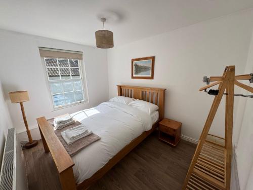 a bedroom with a bed with a cross on the wall at Rustic Elegance Town Centre Flat in Ipswich