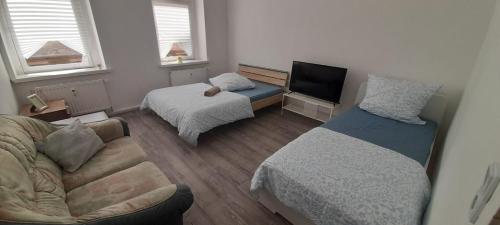 a small living room with a bed and a couch at New flat for 7 Special price per month 4 Rooms in Zeitz