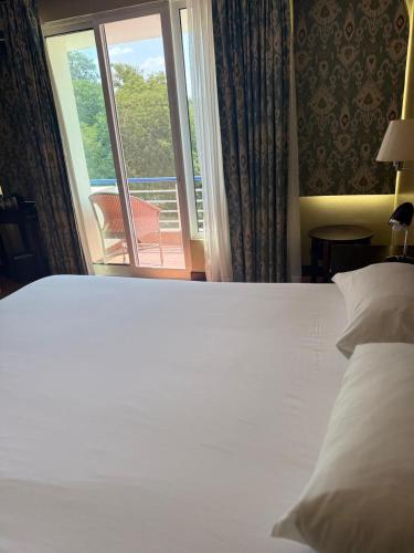 Postel nebo postele na pokoji v ubytování Hotel Cardoso