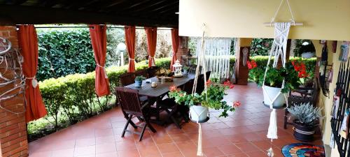 a patio with a table and potted plants at La Casa di Anna in Zagarolo