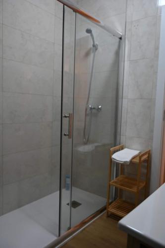 a shower in a bathroom with a glass door at Downtown Cosy in Vila Real