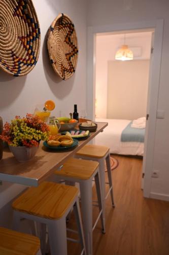a kitchen with a table with food on it at Downtown Cosy in Vila Real