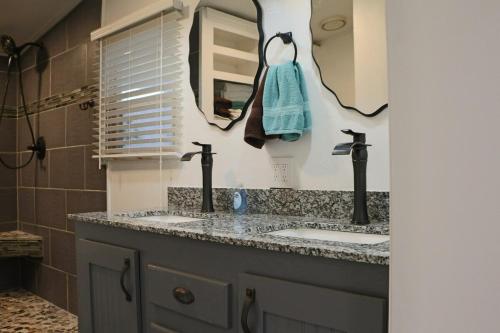 a bathroom with two sinks and a mirror at Cute Shawnee Twin Lakes home sleeps 10&has it all! in Shawnee