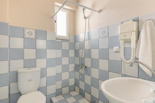 a bathroom with a toilet and a sink at Sofi Hotel in Neokhórion