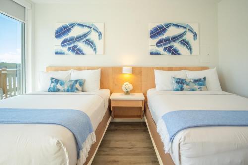 two beds in a room with a window at Gilbert's Resort in Key Largo