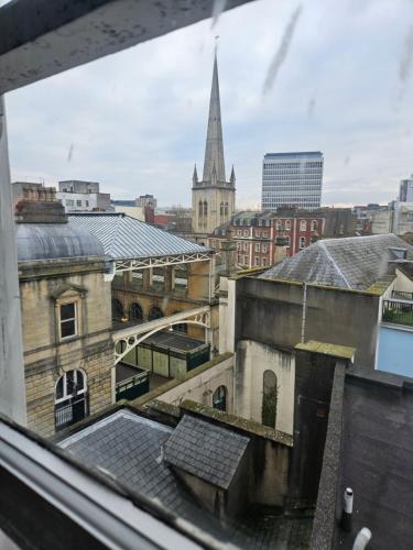 a view from a window of a city with a church at City Centre Location on Corn Street studio in Bristol