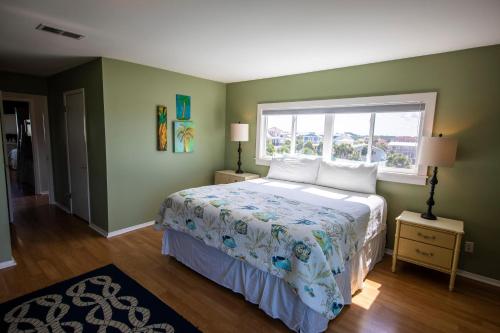 a bedroom with a large bed and a window at Sea Cliffs #10 in Blue Mountain Beach