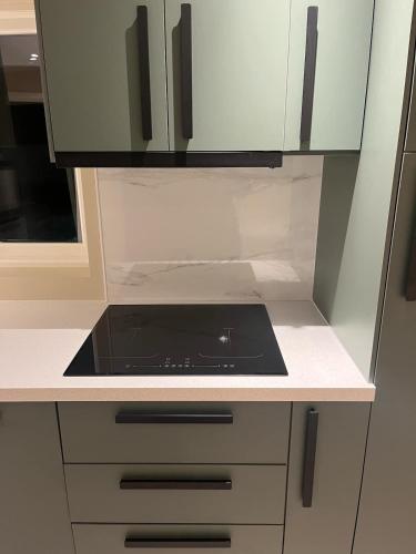 a kitchen with a black stove top in a kitchen at Apartment close to the city center in Sandefjord