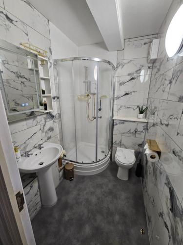 a bathroom with a shower and a toilet and a sink at City Centre Location on Corn Street studio in Bristol