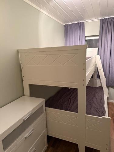a bedroom with a bunk bed with a desk at Apartment close to the city center in Sandefjord