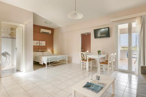 a living room with a bed and a table at Sofi Hotel in Neokhórion