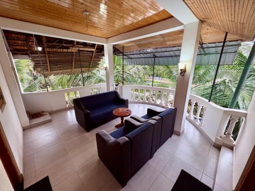 a living room with two couches and a table at Pearl Rest in Mannar