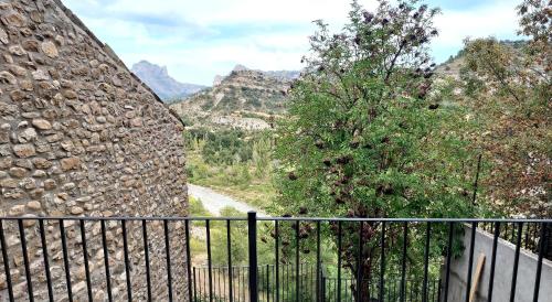 a balcony with a fence and a view of mountains at Casa Chumpón in La Puebla de Roda