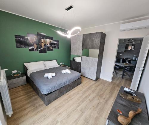 a bedroom with a bed and a green wall at Green Suite Apartment in Santa Maria delle Mole