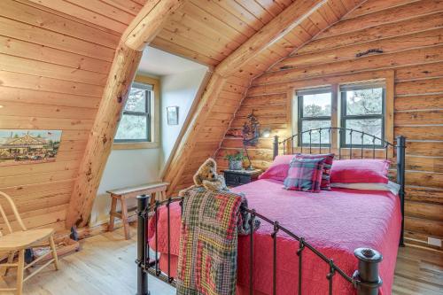 a bedroom with a bed in a log cabin at 18 Mi to Royal Gorge Peaceful Mtn Cabin with Porch! in Cotopaxi