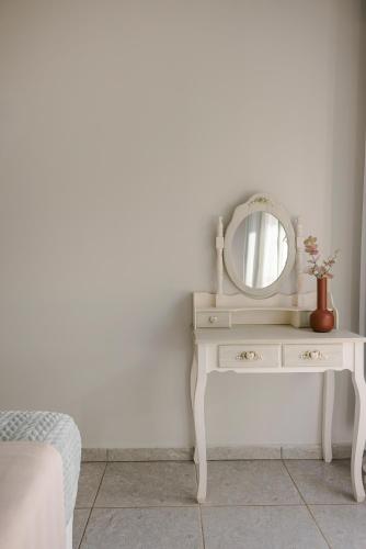 a white dressing table with a mirror on it at Sofi Hotel in Neokhórion