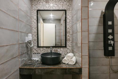 a bathroom with a sink and a mirror at Sofi Hotel in Neokhórion