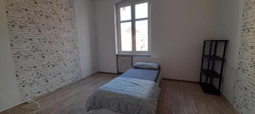 a bedroom with a bed in a room with a window at Beautiful apartment for 5-7 guests in Zeitz