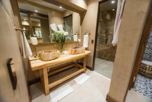 a bathroom with two baskets on a wooden counter with a sink at La Maria Hotel Boutique in Chacras de Coria