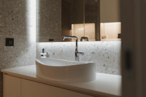 a bathroom with a white sink and a mirror at Apartment MIVIDA in Posušje