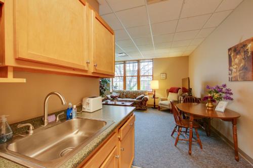 a kitchen with a sink and a table in a room at New Kensington Vacation Rental with Shared Amenities in New Kensington