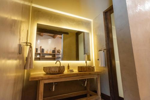 a bathroom with a wooden sink and a mirror at La Maria Hotel Boutique in Chacras de Coria