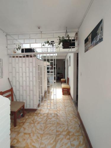 a room with a hallway with chairs and a table at Welcome Home Cali in Cali