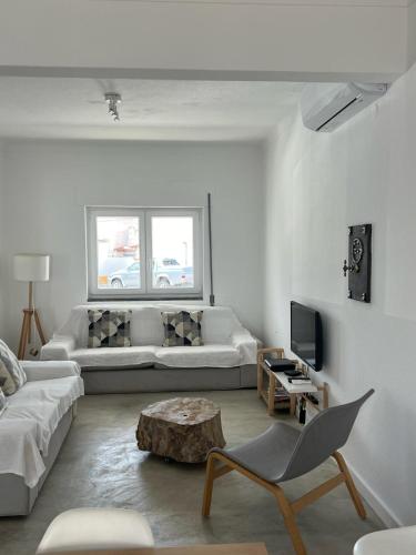 a living room with a couch and a coffee table at Sunshine Patio Getaway in Vila Nova de Milfontes