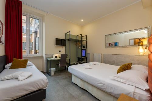 a hotel room with two beds and a desk at Seven in Rome