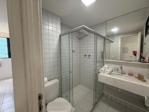 a bathroom with a shower and a toilet and a sink at Edificio Neo Apto 401 in Maceió