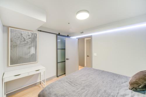 a bedroom with white walls and a bed at Luxe High-Rise 2 Mi to Dtwn Cleveland WFH Ready! in Cleveland