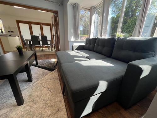 a living room with a couch and a table at Luxury Detached holiday home Near BHX, JLR, NEC in Birmingham