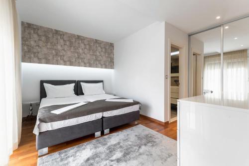 a bedroom with a king sized bed and a bathroom at Hotel - Teranea City Hvar in Hvar