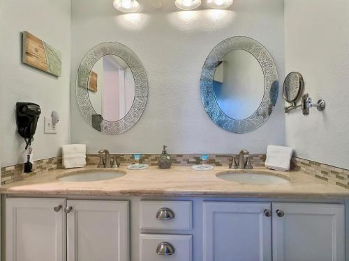 a bathroom with two sinks and two mirrors at Pacific Plaza #608 - Oceano Getaway - 1BdrmUp-K-QSofa in Oceano