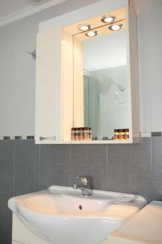 a bathroom with a white sink and a mirror at Laconian Blue Residence in Gythio
