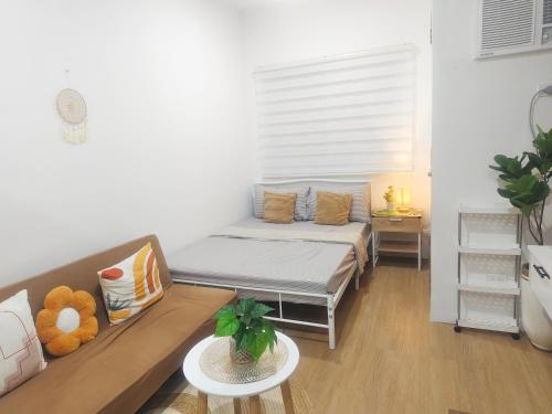 a small living room with a couch and a table at Janna's Condo in Mactan in Lapu Lapu City