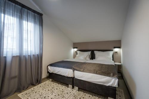 a bedroom with a large bed and a window at Hotel - Teranea City Hvar in Hvar