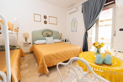 a bedroom with two beds and a table at L'Anfiteatro di Pompei B&B in Pompei