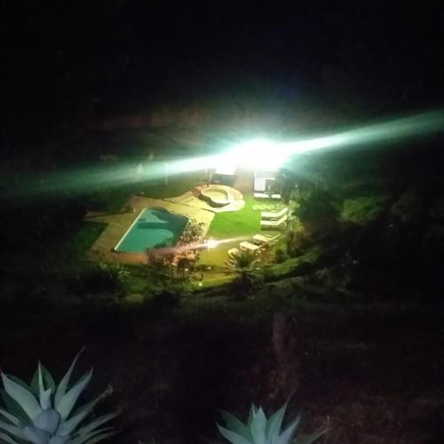 a view of a pool at night with a light at Sitio Bárbara in Brumadinho