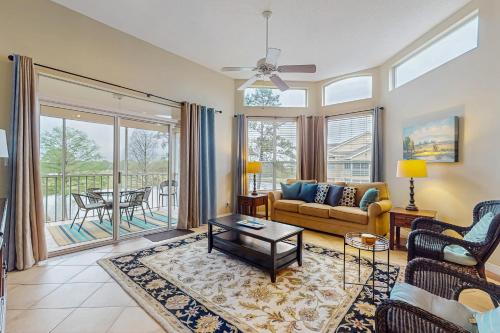 a living room with a couch and a table at Cypress Point Condominiums at Craft Farms #306B in Gulf Shores