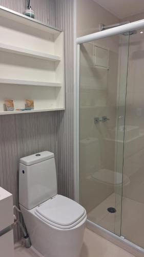 a bathroom with a toilet and a glass shower at Skylux 3003 in Rio de Janeiro