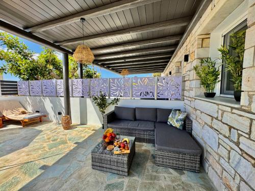 a patio with a couch and a table at La vie est belle Luxury Residence With Jacuzzi '2' in Pounda