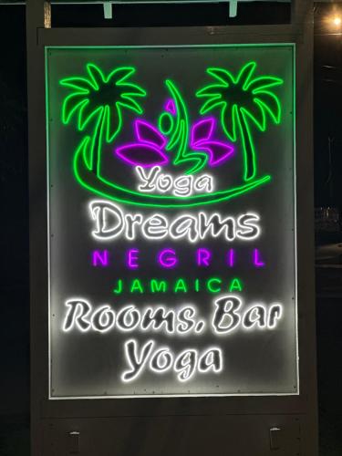 a neon sign that says yoga dreams neccessary tomato tomatoes bar vodka at Yoga Dreams Negril in Negril