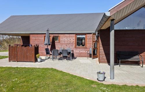 a house with a roof with a table and chairs at Amazing Home In Vinderup With Sauna in Vinderup