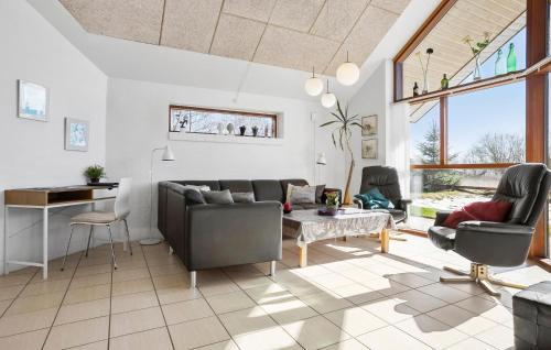 a living room with a couch and a table at Amazing Home In Vinderup With Sauna in Vinderup