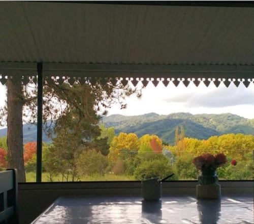 a window with a view of trees and mountains at Ntra Sra de los Angeles in Salta