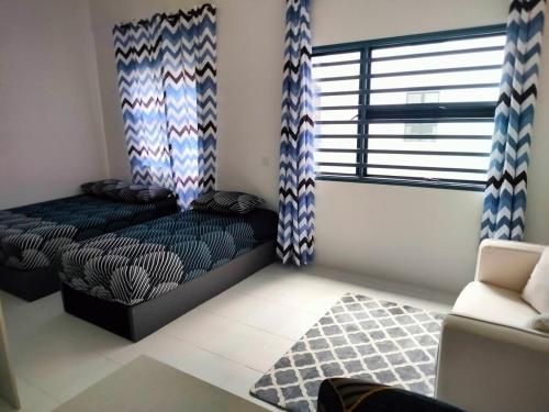 a bedroom with a bed and a window and a couch at IFS SoHo 2 Basic Studio in Seri Iskandar