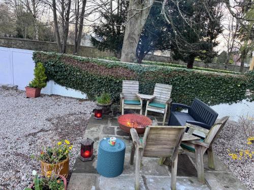 a patio with chairs and a table at 19th century 5-bedroom villa with free private parking in Elgin