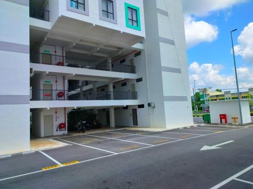 a large white building with a parking lot at IFS SoHo 2 Basic Studio in Seri Iskandar