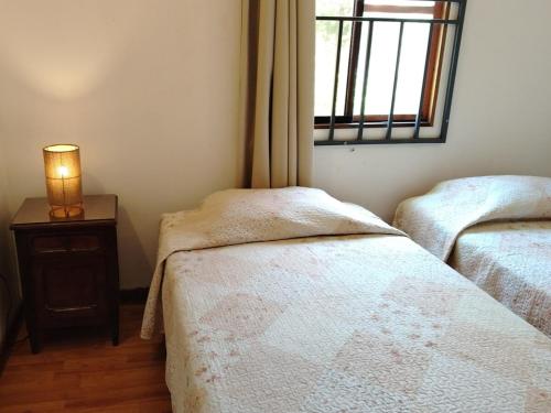 a bedroom with two twin beds and a window at Rural retreat pool, 6ppl - 5min beach - SuperHost in Mala
